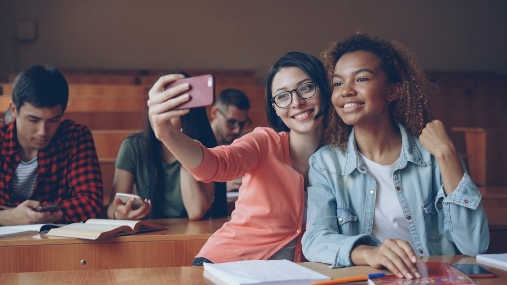 University students smiling together in a lecture hall